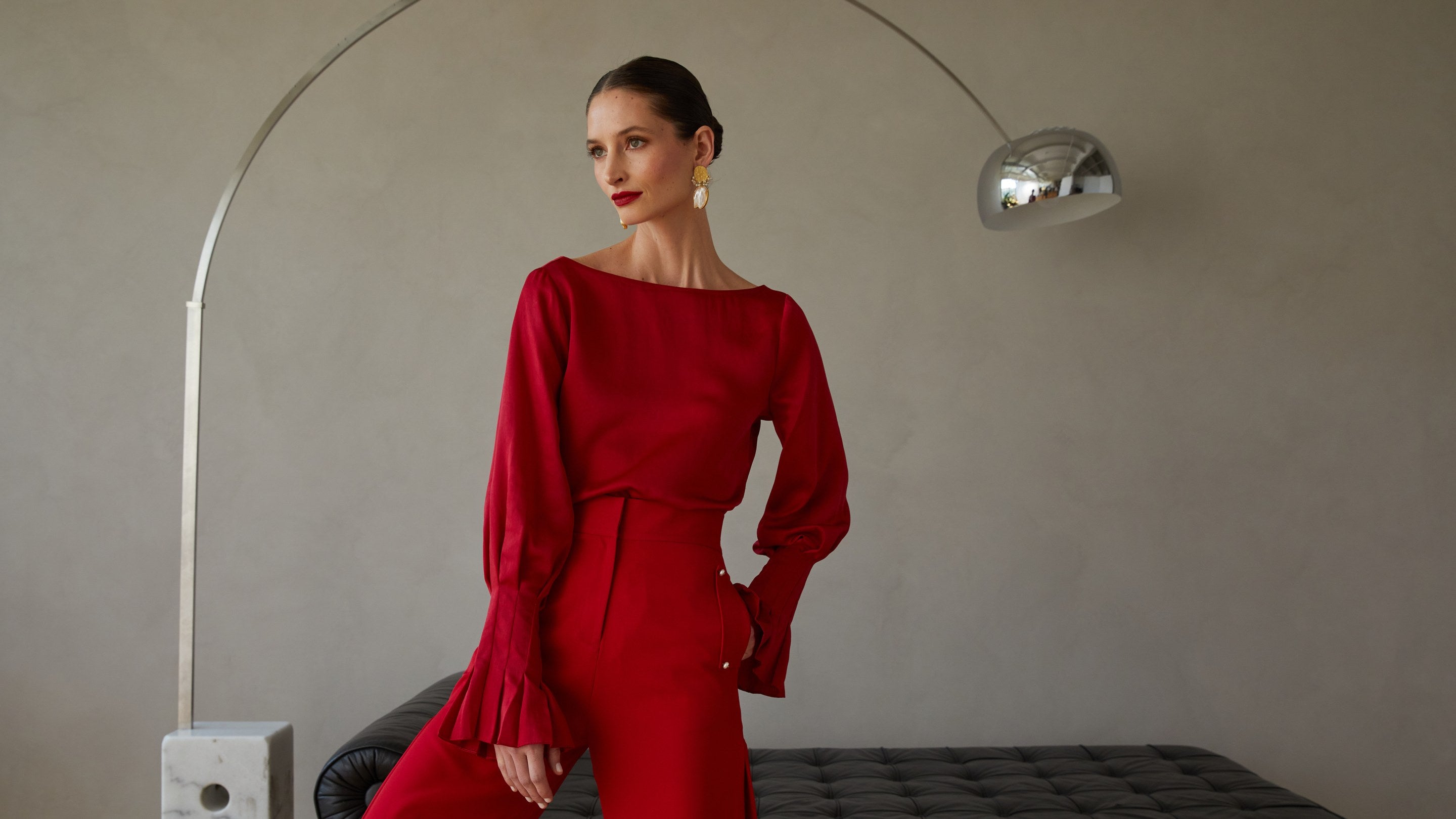 Fall 2026 campaign, crimson blouse with pleated cuffs and matching trousers