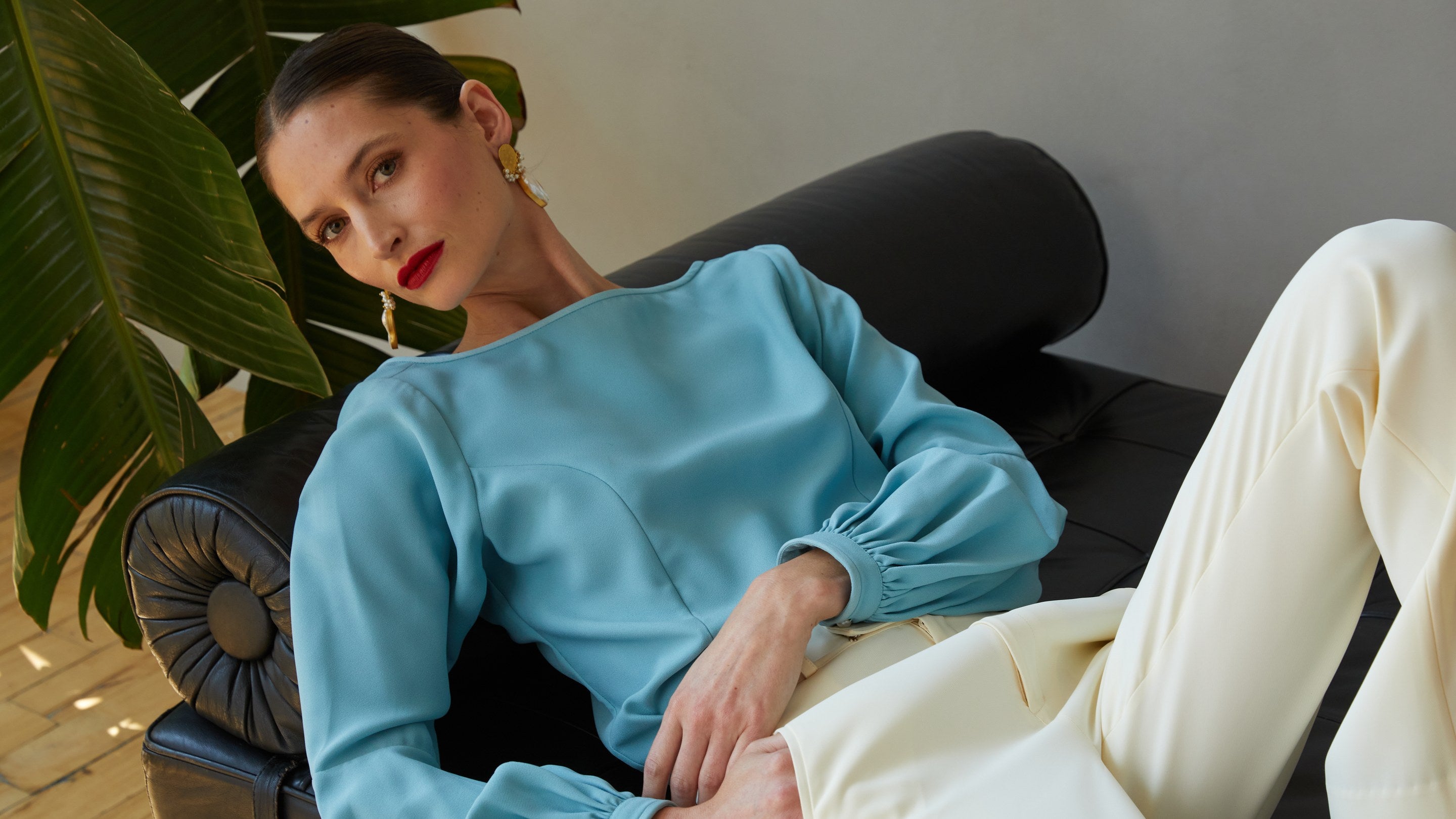 Fall 2026 campaign, sky blue blouse with gathered cuffs and ivory trousers